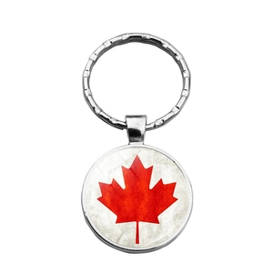 Metal keychain featuring a round pendant with the red Canadian maple flag on white background
