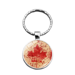 Detailed view of a silver metal keychain with a vintage-style Canadian maple leaf pendant