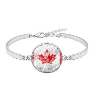 Detail view of the silver metal bracelet with a lobster clasp and Canada flag pendant