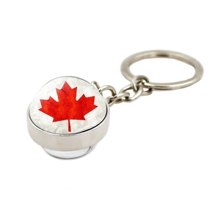 Silver metal keychain with round Canada red maple leaf pendant on white background