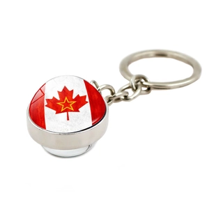 Macro detail of silver alloy keychain featuring Canada flag glass dome with red maple leaf