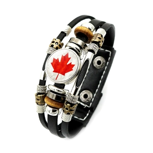 Close-up of multilayer leather bracelet with Canada maple leaf glass dome and snap buttons