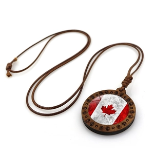 Vintage Canadian flag pendant necklace featuring rustic wood frame and red maple leaf design