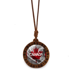 Detailed macro view of wood pendant necklace with Canadian flag maple leaf design