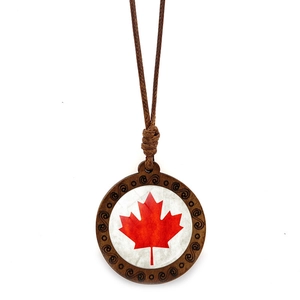 Detailed close-up of Canada flag maple leaf pendant with brown wood carved frame