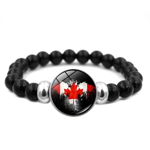 Detail of beaded bracelet with black beads and Canada flag maple leaf charm