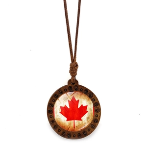 Vintage wooden necklace featuring Canada flag maple leaf pendant on white background
