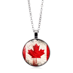 Detailed close-up of the vintage Canadian maple leaf pendant with a glass dome cover