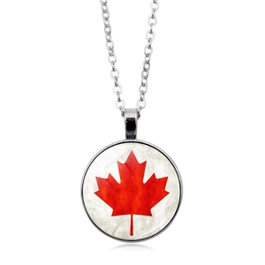 Close-up of a round silver necklace featuring a red maple leaf on a white background