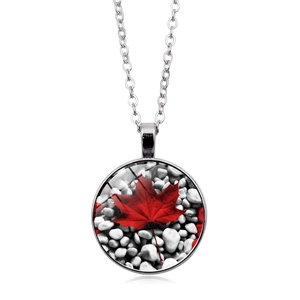 Close-up of a Canada flag maple leaf pendant necklace with pebble texture and silver chain
