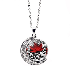 Detailed close-up of double-sided rotating moon pendant with Canadian flag maple leaf pattern