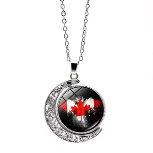 Artistic Canada flag moon necklace detail featuring red maple leaf and vintage silver texture