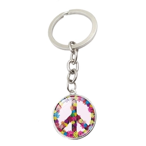Close-up of peace sign keychain featuring a colorful floral daisy pattern under glass