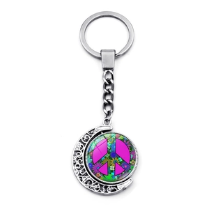 Bohemian peace sign keychain with rotating moon pendant and floral pattern on white background
