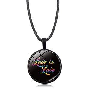 Macro shot of circular pendant with Love is Love rainbow text and black woven cord