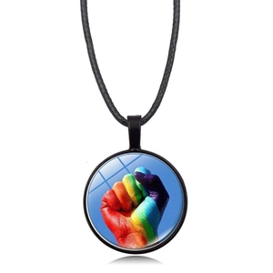 Macro detail of a round rainbow heart pendant necklace with a black woven cord strap
