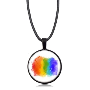 Detail view of round rainbow heart pendant with black cord necklace on white background