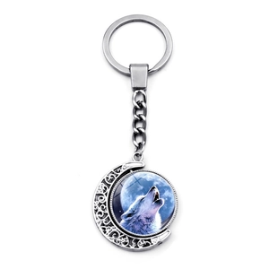 Rotating crescent moon howling wolf pendant keychain with silver plated metal frame