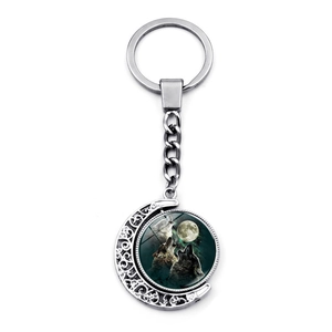 Rotating moon howling wolf pendant keychain in silver alloy with celestial art charm
