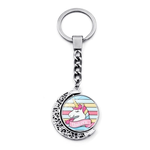 Rotating silver metal keychain with moon pendant and cute cartoon unicorn illustration
