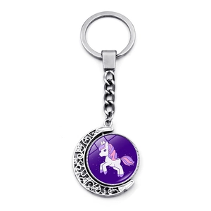 Detail of silver crescent moon keychain featuring a purple cartoon unicorn glass cabochon