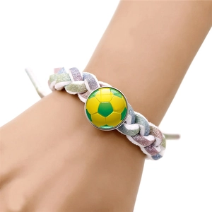 Handmade woven soccer themed bracelet with green and yellow pattern on adjustable wristband