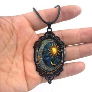 Vintage oval sun and moon pendant necklace with celestial star pattern and black cord