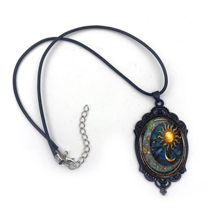 Retro oval pendant necklace featuring sun and moon celestial theme with black cord chain