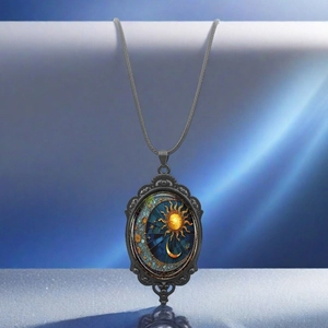 Detail view of oval celestial pendant with sun moon and star patterns on woven cord