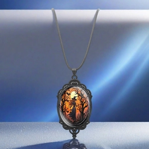 Gothic vintage oval pendant necklace with witch and forest scene in spooky sunset