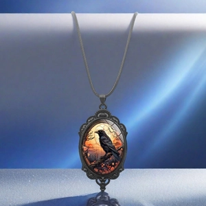 Detailed close-up of gothic crow oval pendant with ornate lace edges on a cord