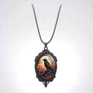 Oval necklace with black raven and sunset illustration on black leather cord