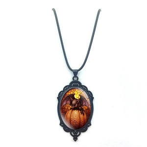 Close-up of Gothic Halloween necklace featuring a bat and pumpkin on an oval lace pendant