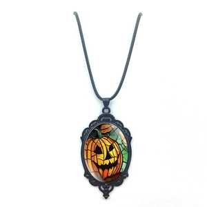Gothic Halloween necklace featuring a detailed Jack-o'-lantern pendant on black cord