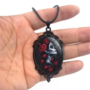 Gothic necklace featuring a black oval pendant with a red rose and skull woman portrait