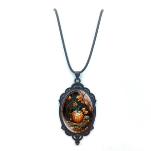Gothic vampire bat style pumpkin necklace with vintage black metal frame on white background