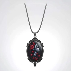 Gothic necklace featuring a black oval skull pendant with vibrant red roses on black cord