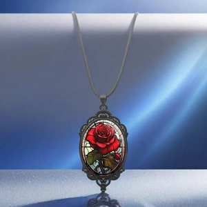 Vintage oval pendant necklace featuring a red rose pattern in a black embossed metal frame