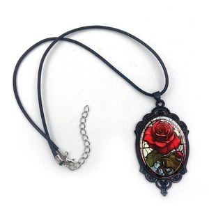 Vintage red rose oval pendant necklace with black ornate metal frame and cord chain