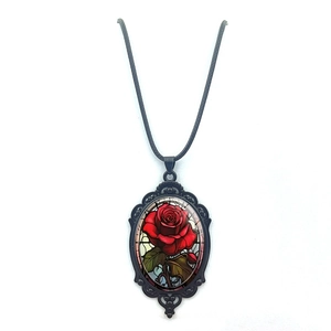Vintage oval pendant necklace featuring red rose art in a black baroque hollow frame