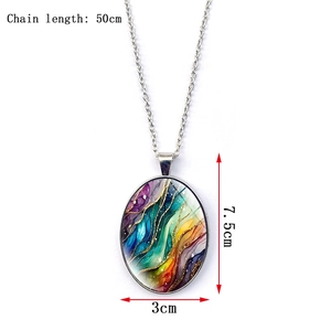 Detail view of large oval pendant with colorful fluid art and gold glitter patterns