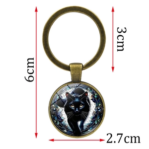 Mystic black cat keychain with bronze finish and glass pendant featuring yellow eyes