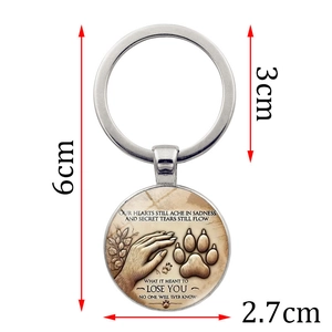 Silver metal pet memorial keychain with paw print design and 6cm total length dimensions