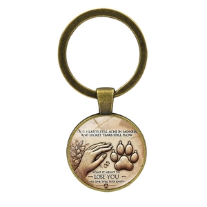 Bronze pet memorial keychain featuring hand and paw print design with sentimental text
