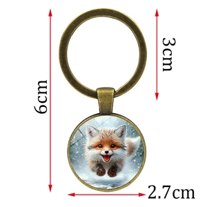 Round bronze fox keychain with a cute snowy fox illustration and 6cm size dimensions