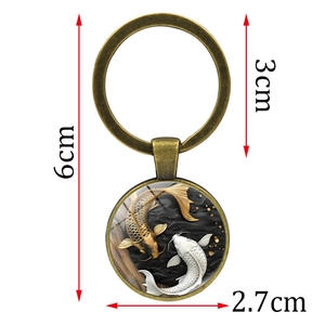 Antique bronze keychain featuring Yin Yang koi fish glass cabochon pendant