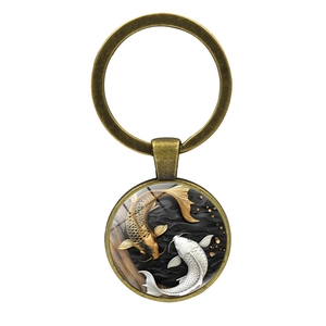 Vintage bronze yin yang koi fish keychain with embossed double fish art on white background