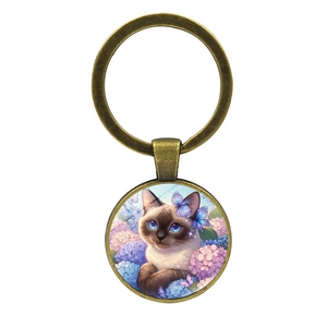 Vintage bronze Siamese cat and butterfly pendant keychain with blue floral art