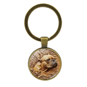 Vintage bronze French Bulldog keychain with detailed floral relief and retro metal finish