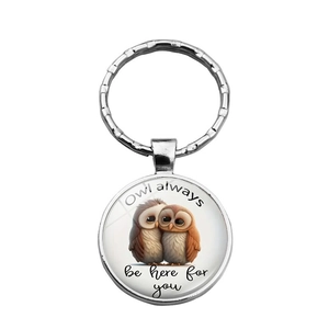 Detail of owl keychain with 'Owl always be here for you' quote on round metal pendant